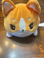 Angry face side of reversible corgi plush