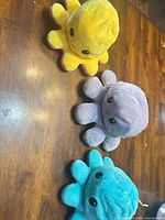 All three octopus plush toys on table