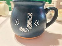 Front view showing plaid J monogram and overall shape