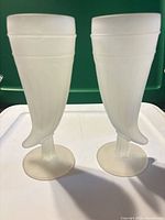 Front view of both frosted powder horn pilsner glasses showing shape and condition