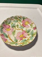 Full view of saucer showing dogwood blossom pattern and gold rim