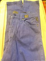 Full pair of cobalt blue Versace Jeans Couture denim jeans