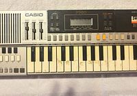 Front view showing full keyboard, speaker grill, control panel