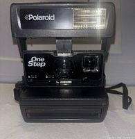 Front view showing lens, flash, branding, green power light