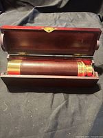 Telescope inside open wooden case