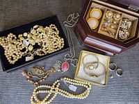 Overview of assorted jewellery, pearl necklaces, watches, bracelets and wood jewellery box