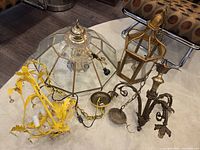 Group shot of four chandeliers on floor showing overall types and condition