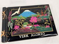 Front cover showing lacquer artwork, spine ties, and name