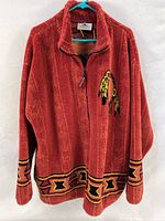 Front view of rust red Black Mountain fleece jacket with dreamcatcher graphic and southwestern border trim