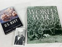 Front covers of both books and the vintage Navy photograph