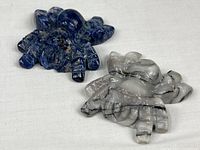 Both stone spider figurines together, showing size and colors