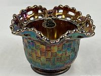 Full view of ruffled lattice-rim carnival glass bowl showing exterior basket-weave pattern and iridescent finish