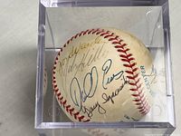 Overall view of signed baseball in acrylic cube with visible autographs