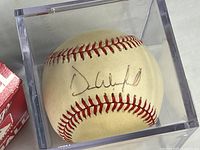 Autograph side of baseball in cube