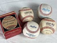 Group shot of four baseballs and Spalding box