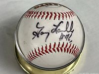 Autographed baseball in case showing signature