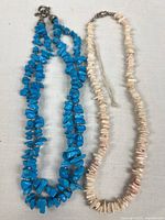 Both necklaces laid flat showing overall appearance