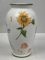 Front view showing sunflower motif and green rim/base bands