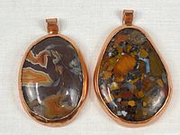 Front view of both copper-electroplated stone pendants