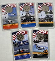 All five sealed commemorative coin packs front view