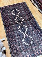 Full view of the entire rug laid flat showing complete pattern and condition