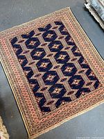 Full view of handmade Persian rug showing design and borders