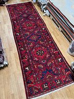 Full view of entire Persian runner rug showing pattern and colors