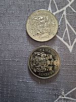 Reverse sides showing Canadian Coat of Arms on 1978 and 1981 50 cent coins