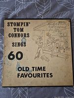 Front of album cover showing title, artist and wear marks