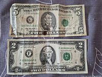 Obverse of $5 and $2 notes showing serial numbers, portraits, seals and wear