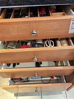 Open drawer showing assorted cutlery and utensils