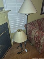 Both lamps side by side near fireplace and sofa