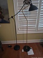 Two floor lamps side by side showing overall design and shades