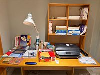 Overall view of desk showing printer, lamp, office supplies