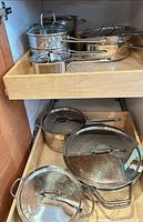 Drawer with stainless pots and pans with lids
