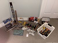 Overall lot layout showing hand tools, cords, bulbs and accessories