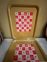 Two trays displayed upright and flat showing full pictogram graphic.