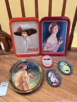 Overview of six Coca-Cola trays on floor