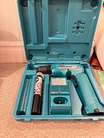 Drill, charger, battery and case overall view