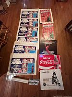 All posters and metal sign laid out on floor