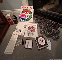 Full lot overview showing glasses, signs, radio, pamphlets, playing cards and binder