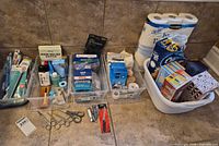 Overview of bins with dental items, first aid supplies, scissors, tissue products