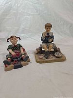 Both figurines front view side by side