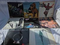 Group shot of all eight LPs laid out, showing full front covers