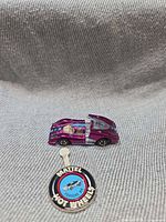 Side view of Porsche 917 with engine hatch open and button foreground