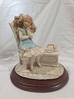 Front angle of signed A. Belcari resin figurine on wood base