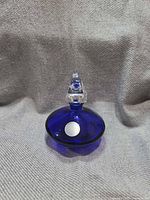 Front view of cobalt blue perfume bottle with clear pyramid stopper