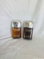 Front view of both Chaps bottles showing labels and caps