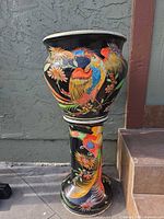 Planter on pedestal front view showing bird and floral design