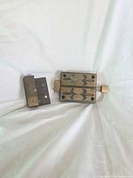 Front view of rim lock and keeper showing decorative faceplates